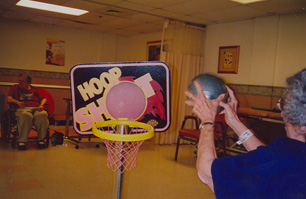 A basketball game is a fun aspect of this resident's therapy program, as she prepares to return home.